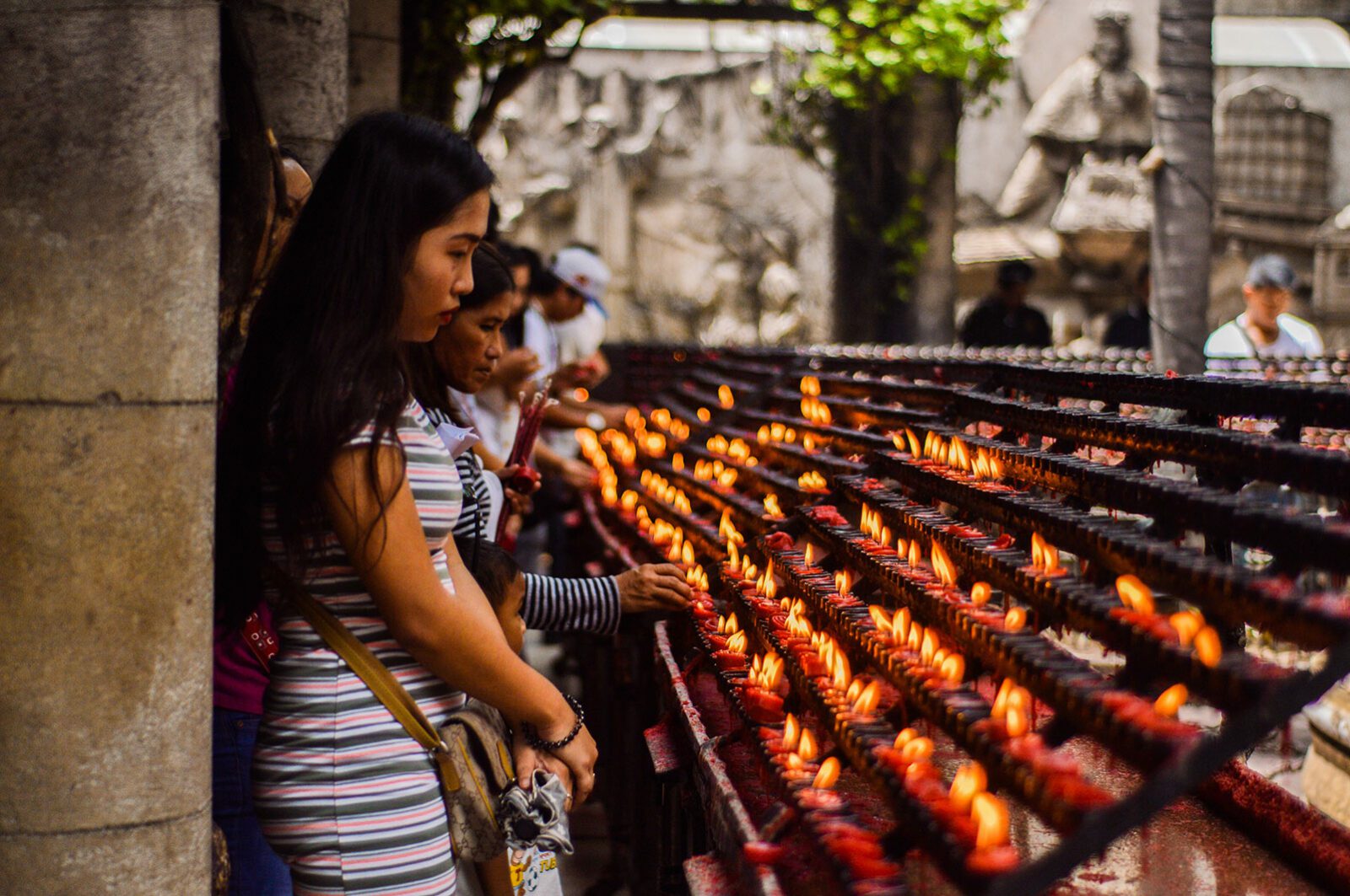 women lighting candles