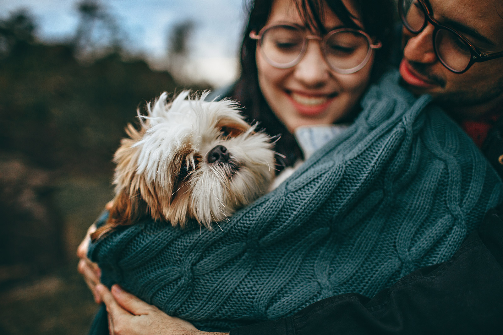 man and woman holding each other and a dog