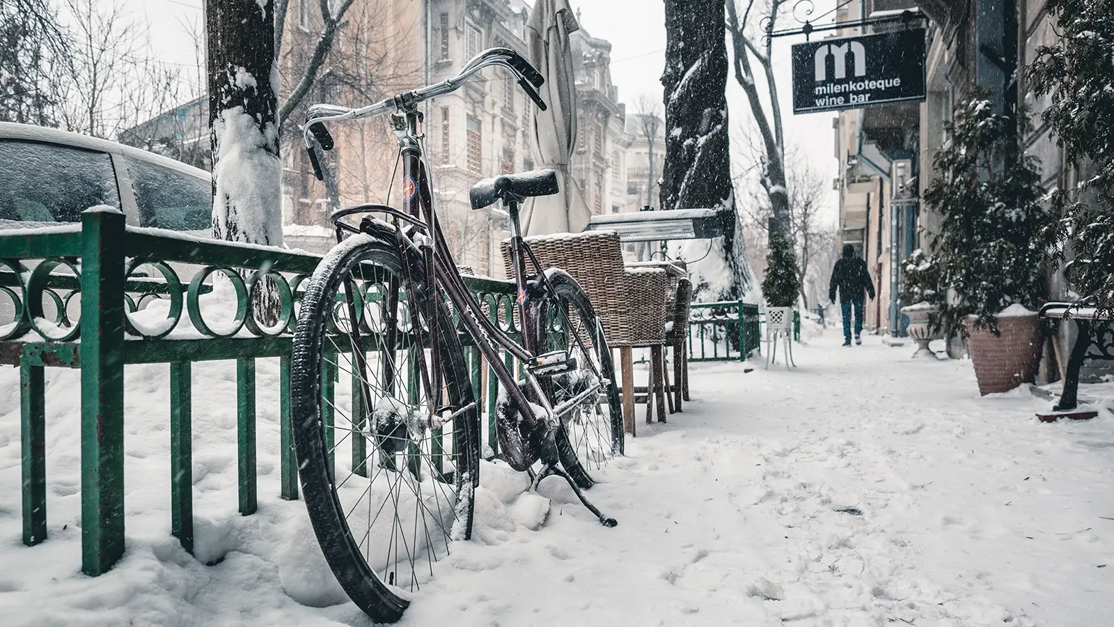 a sidewalk in a city completely covered in snow