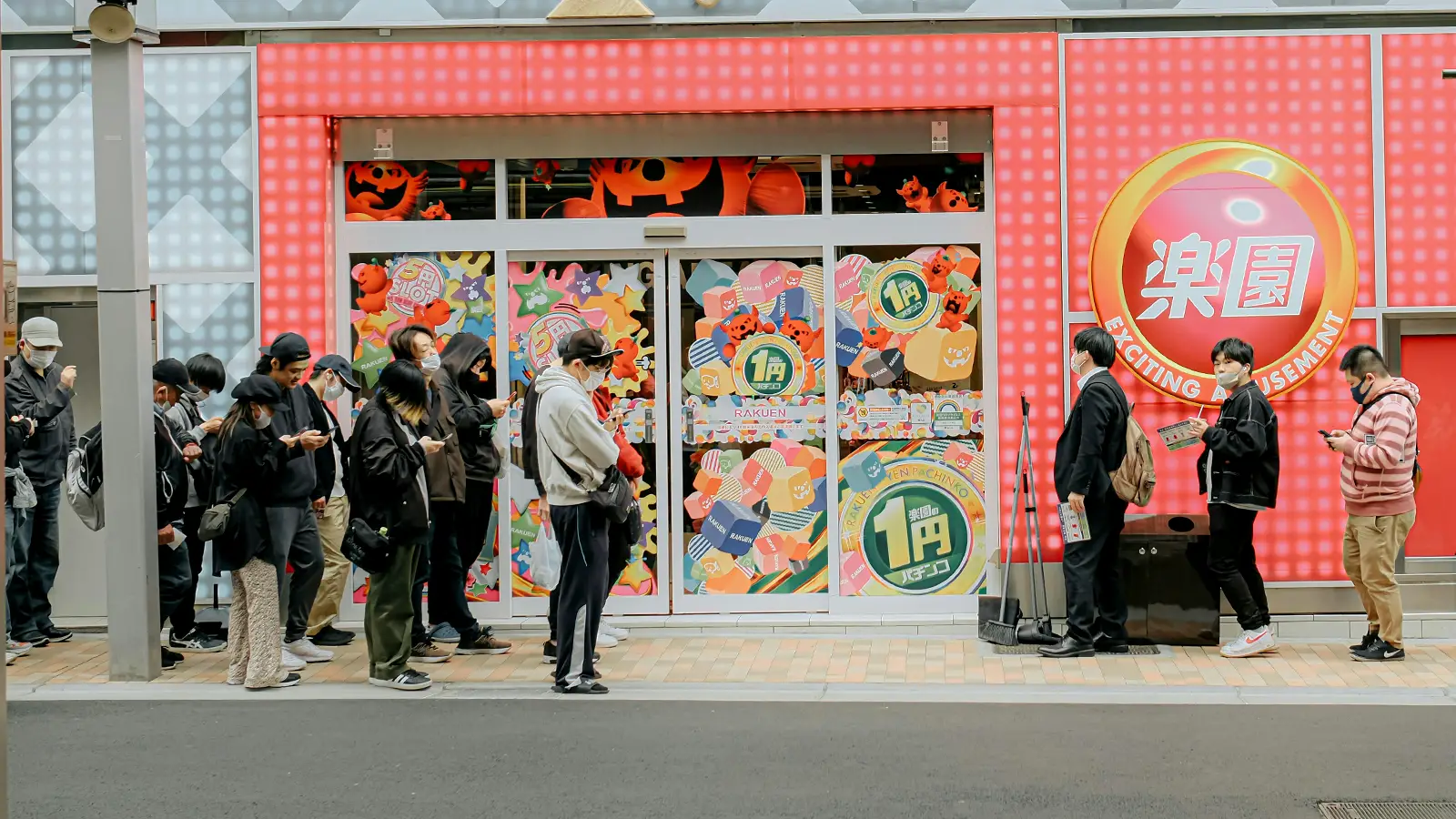 a line of people waiting in front of a store for it to open