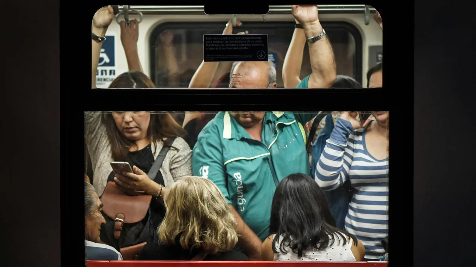 a mix of diverse people crowded into a subway