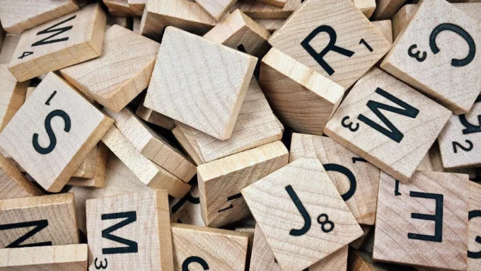 a pile of scrabble word game tiles with letters on them.
