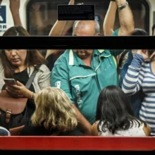 a mix of diverse people crowded into a subway car