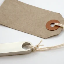 a usb thumb drive attached to a paper tag