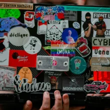 a laptop with lots of stickers on it