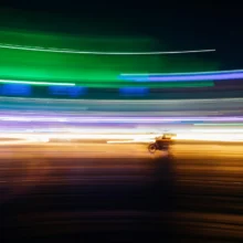 streaks of color and a motorcycle produced by time lapse photography