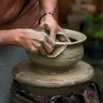a white woman creating a clay pot on a potter's wheel