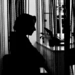 black and white silhouette of a woman pensively looking into the distance