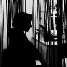 black and white silhouette of a woman pensively looking into the distance