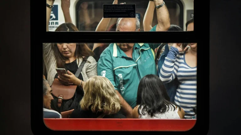 a mix of diverse people crowded into a subway