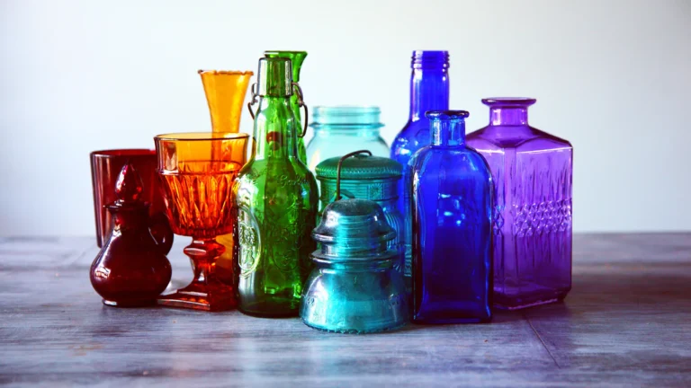 a group of colored glass jars and containers