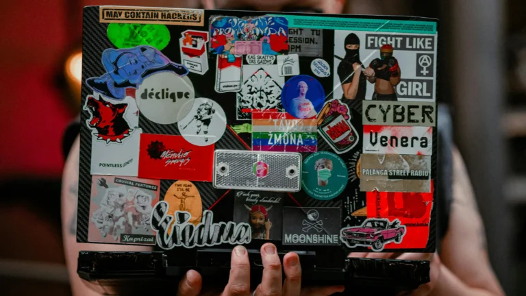 a laptop with lots of stickers on it