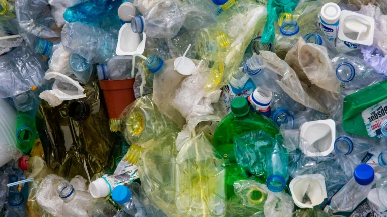 a pile of plastic bottles crumpled up for recycling