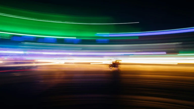 streaks of color and a motorcycle produced by time lapse photography