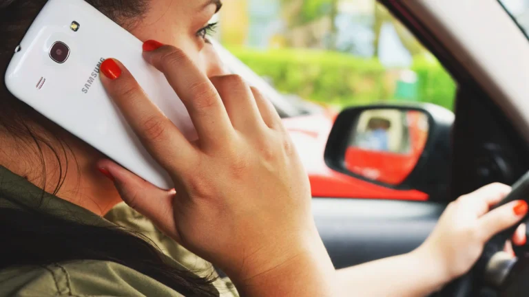 woman driving while talking on phone