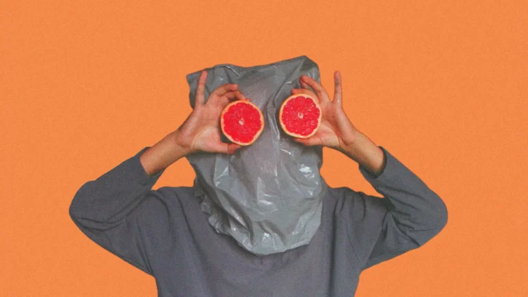 person with bag over head and grapefruits for eyes