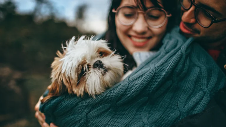 man and woman holding each other and a dog